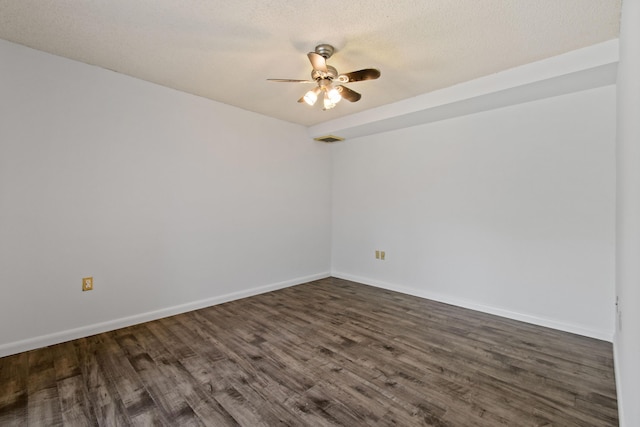 spare room with ceiling fan, dark hardwood / wood-style floors, and a textured ceiling