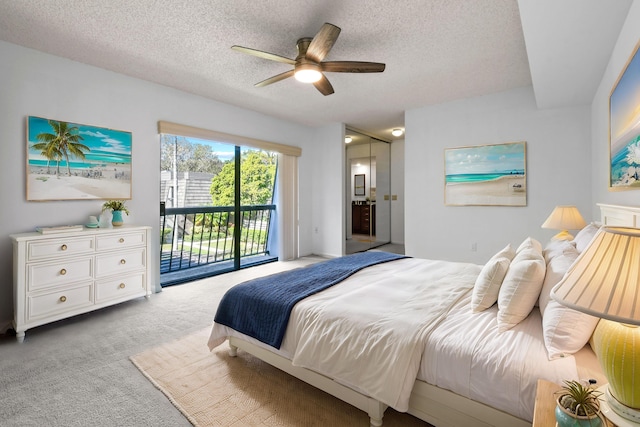 bedroom with a textured ceiling, access to outside, light colored carpet, and ceiling fan