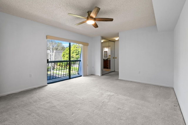 unfurnished room featuring ceiling fan, carpet flooring, and a textured ceiling