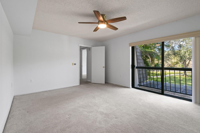 carpeted empty room featuring ceiling fan and a textured ceiling