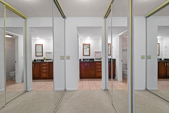 bathroom featuring vanity, tile patterned floors, and toilet