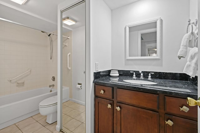 full bathroom featuring tile patterned flooring, vanity, tiled shower / bath combo, and toilet