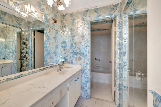 full bath with tile patterned flooring, a garden tub, vanity, and wallpapered walls