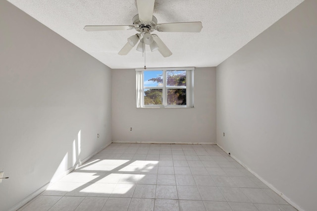 spare room with ceiling fan and a textured ceiling