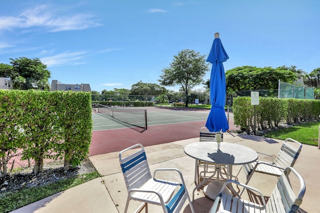 view of sport court featuring fence