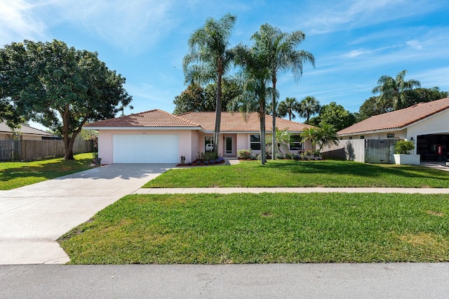 single story home with a garage and a front lawn