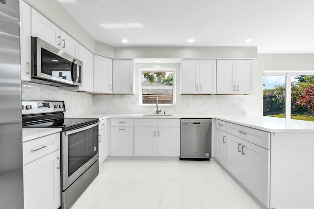 kitchen featuring sink, plenty of natural light, white cabinets, and appliances with stainless steel finishes