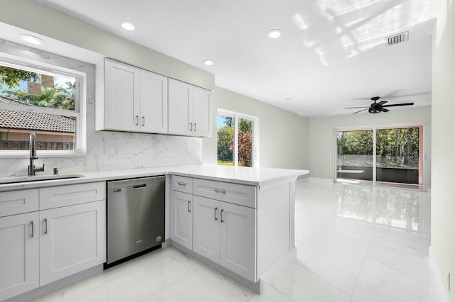 kitchen with tasteful backsplash, dishwasher, sink, ceiling fan, and kitchen peninsula