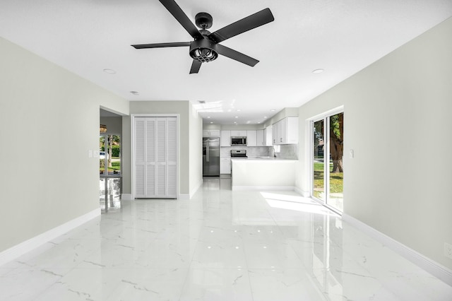 unfurnished living room featuring ceiling fan