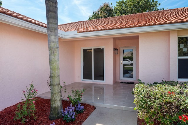 property entrance featuring a patio area