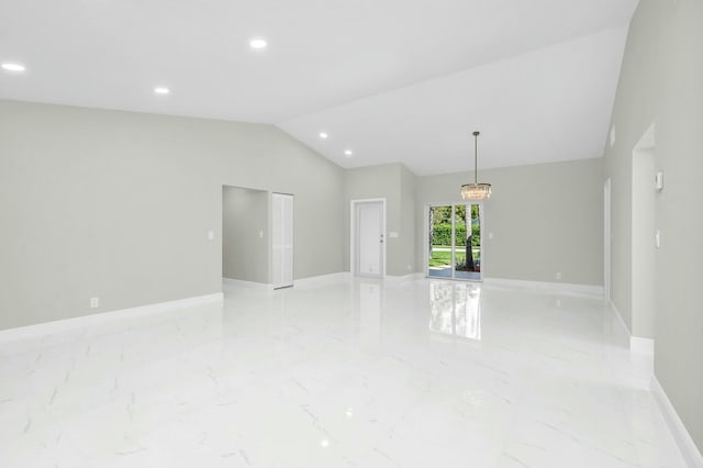 unfurnished room featuring lofted ceiling