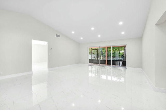 unfurnished room featuring high vaulted ceiling