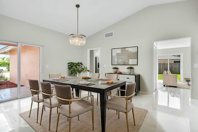 dining room featuring high vaulted ceiling and an inviting chandelier