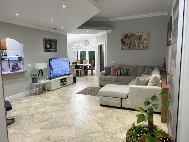 living room featuring lofted ceiling, a notable chandelier, and ornamental molding