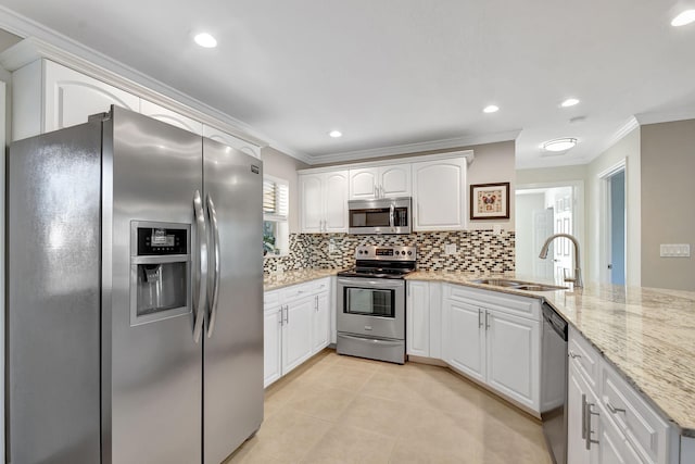 kitchen with sink, light stone counters, crown molding, appliances with stainless steel finishes, and white cabinets