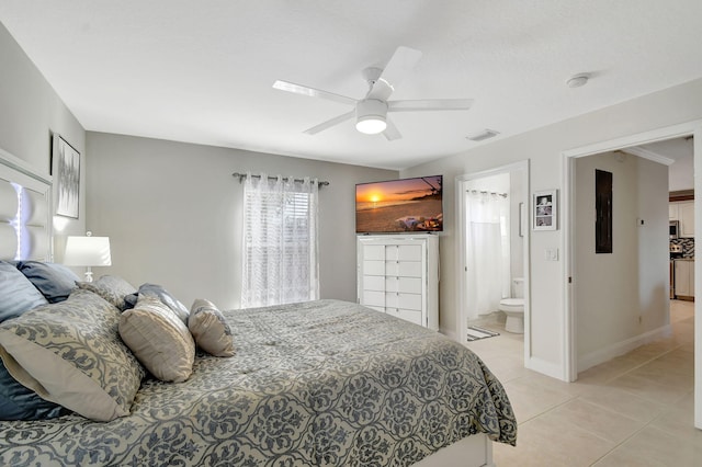 tiled bedroom featuring ensuite bath and ceiling fan