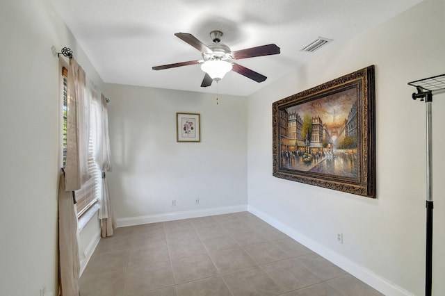 tiled empty room with ceiling fan