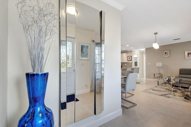 interior space featuring ornamental molding and light tile patterned flooring