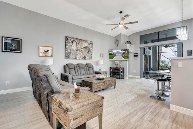 living room featuring ceiling fan, vaulted ceiling, and hardwood / wood-style floors