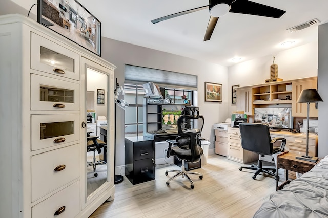 office with ceiling fan and light hardwood / wood-style flooring