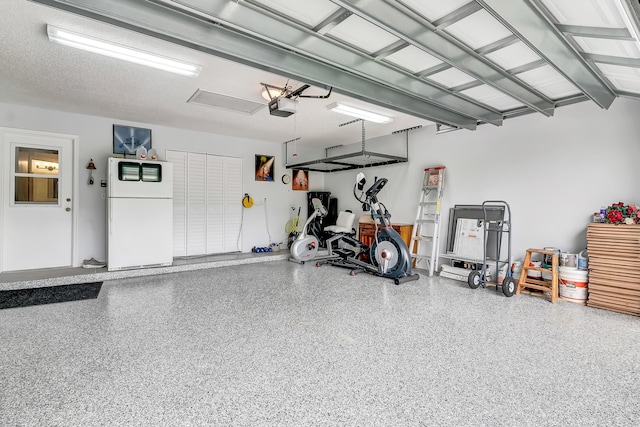 garage with white refrigerator and a garage door opener