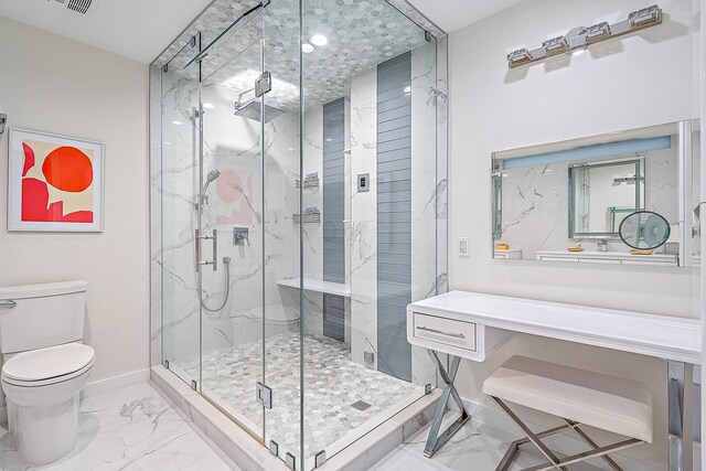 bathroom featuring a shower with door, vanity, and toilet