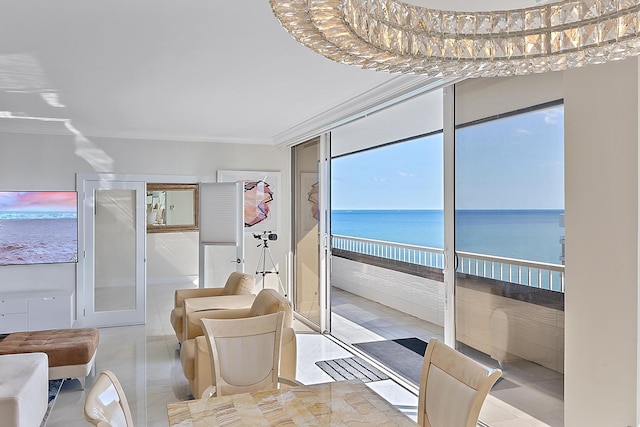 sunroom featuring a water view