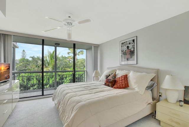 bedroom featuring multiple windows, a wall of windows, ceiling fan, and light carpet