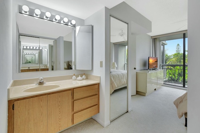 bathroom featuring a wall of windows and vanity