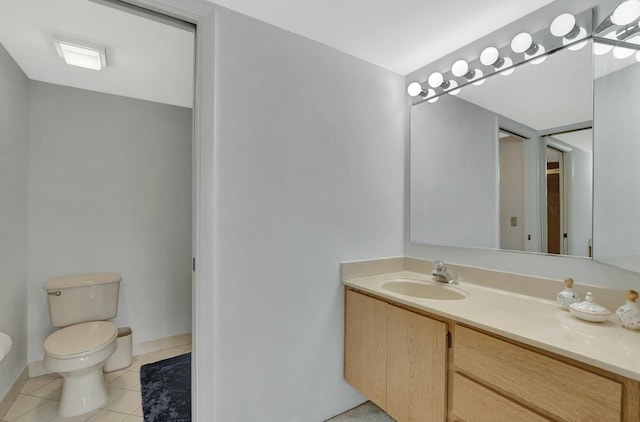 bathroom with tile patterned flooring, vanity, and toilet