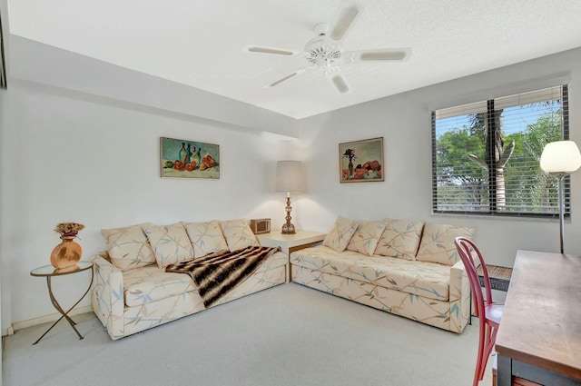 carpeted living room with a textured ceiling and ceiling fan