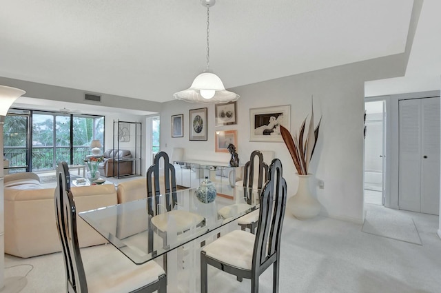 dining space with light carpet