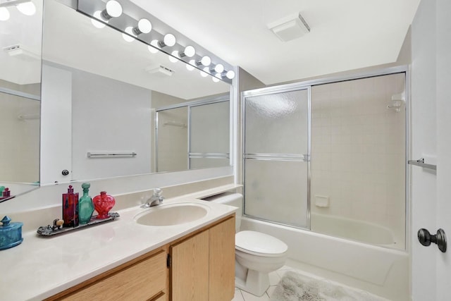 full bathroom with vanity, combined bath / shower with glass door, tile patterned floors, and toilet