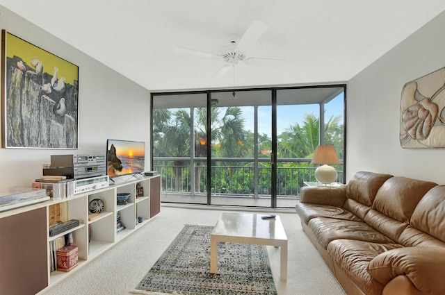 carpeted living room featuring expansive windows, ceiling fan, and a healthy amount of sunlight