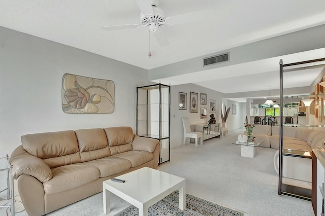 carpeted living room featuring ceiling fan