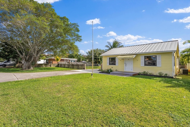 single story home featuring a front yard and central air condition unit