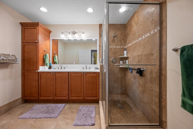 bathroom with vanity, tile patterned flooring, and a shower with shower door