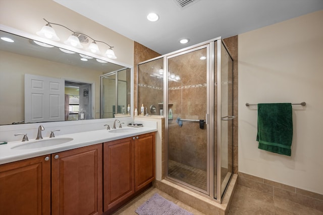 bathroom featuring vanity, tile patterned floors, and walk in shower