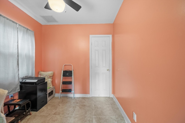 interior space featuring light tile patterned floors and ceiling fan