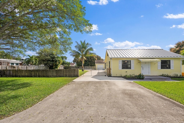 view of front of house with a garage and a front lawn