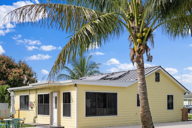 back of house with solar panels