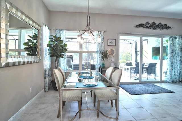 tiled dining room featuring an inviting chandelier and plenty of natural light