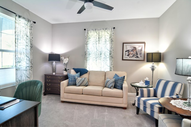 carpeted living room featuring ceiling fan