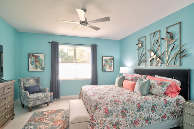 tiled bedroom featuring ceiling fan