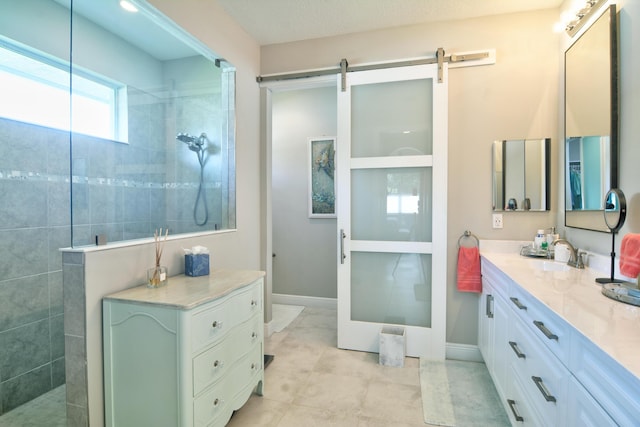 bathroom with vanity and tiled shower