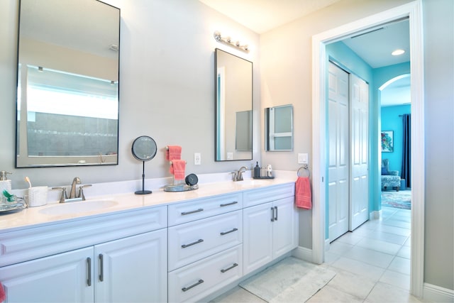 bathroom featuring tile patterned flooring and vanity