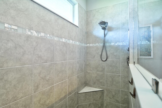 bathroom with a tile shower