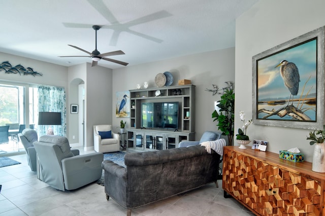 tiled living room with ceiling fan