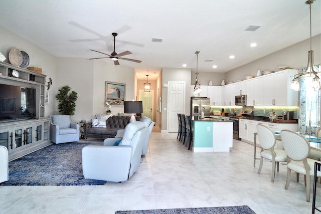 living room featuring light tile patterned flooring and ceiling fan