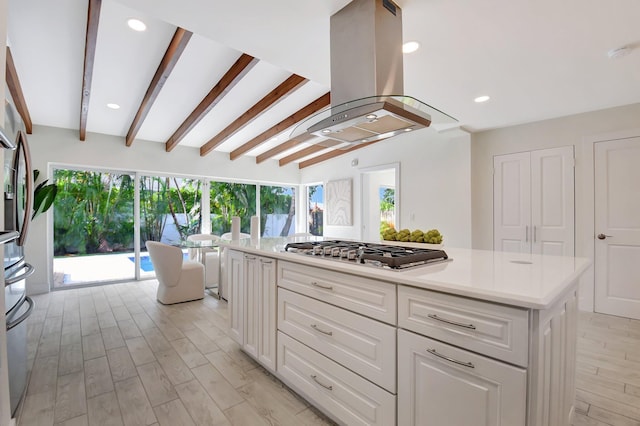 kitchen featuring white cabinetry, stainless steel gas stovetop, light hardwood / wood-style flooring, a kitchen island, and island exhaust hood